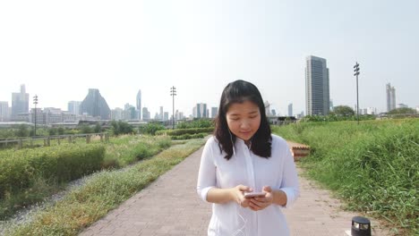 an asian woman in public park.