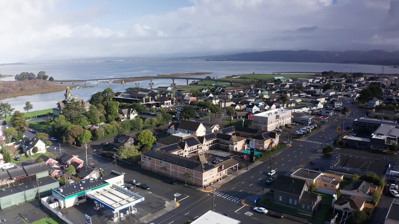 Aerial wide reverse pullback shot of a motel in downtown Eureka, California. 4K