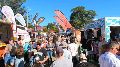 crowded event with diverse food stalls and visitors