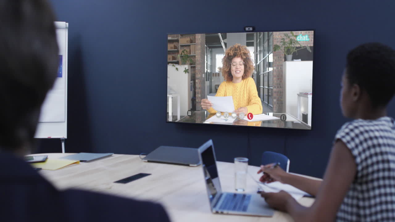 Diverse business people on video call with african american female colleague on screen