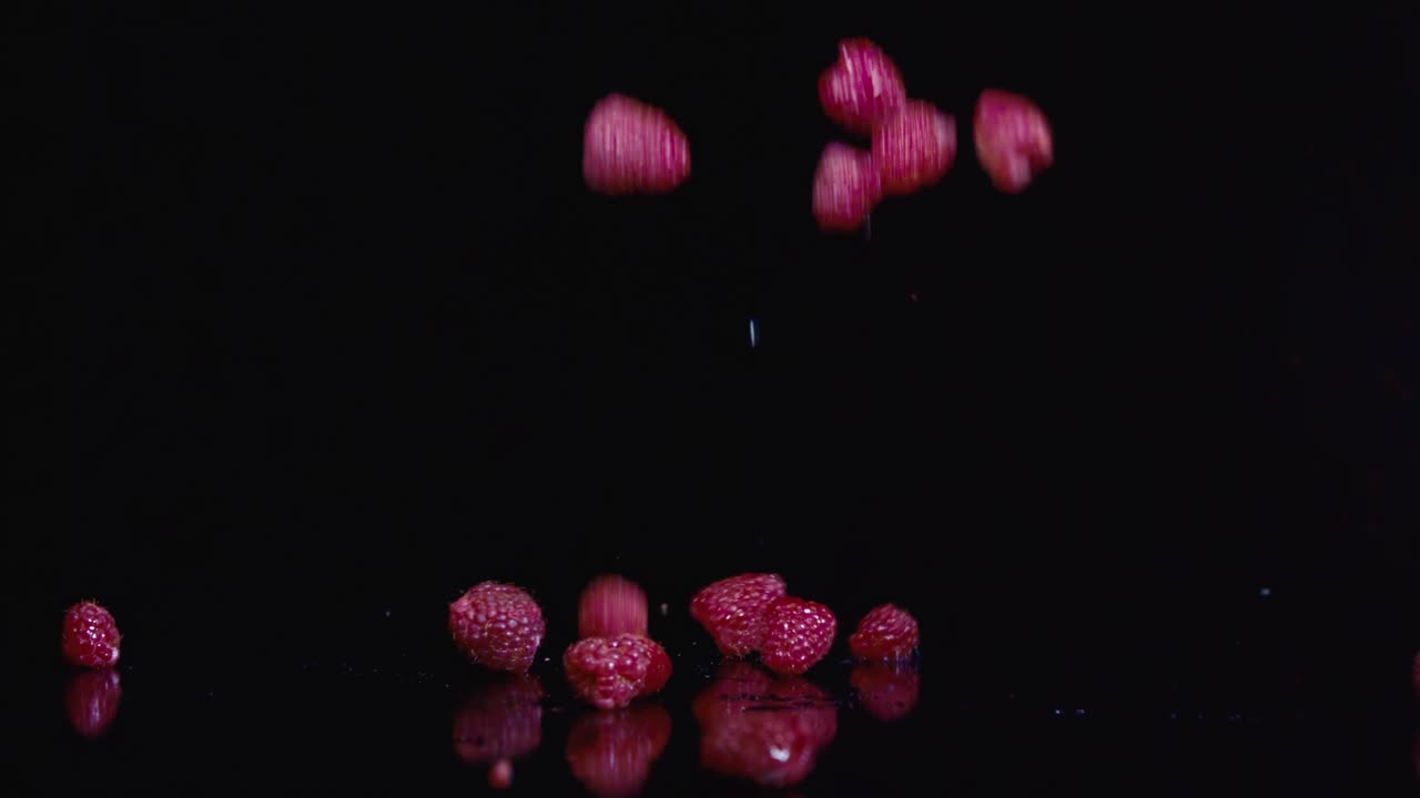 Fresh raspberries isolated on black background