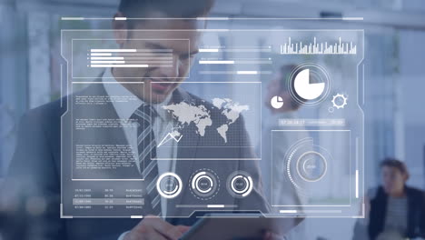 Animation-of-graphs,-loading-circles-and-map-over-caucasian-man-using-digital-tablet-in-office