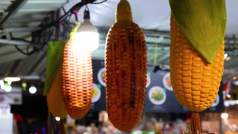 grilled corn displayed at a vibrant night market