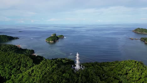 aerial orbit of bote lighthouse with ocean and islands in distance, catanduanes, philippines