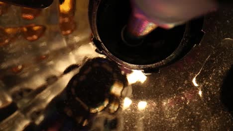 moving towards reflective portion of a disco ball where light is coming off silver surface - great detail is seen in it