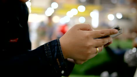 Hands of woman using smartphone select focus shallow depth of field