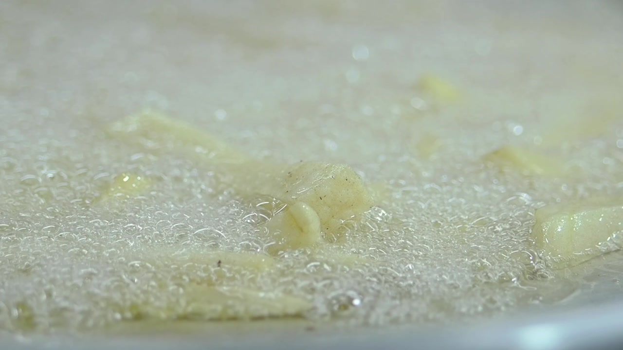 French Fries Frying in Bubbling Hot Oil