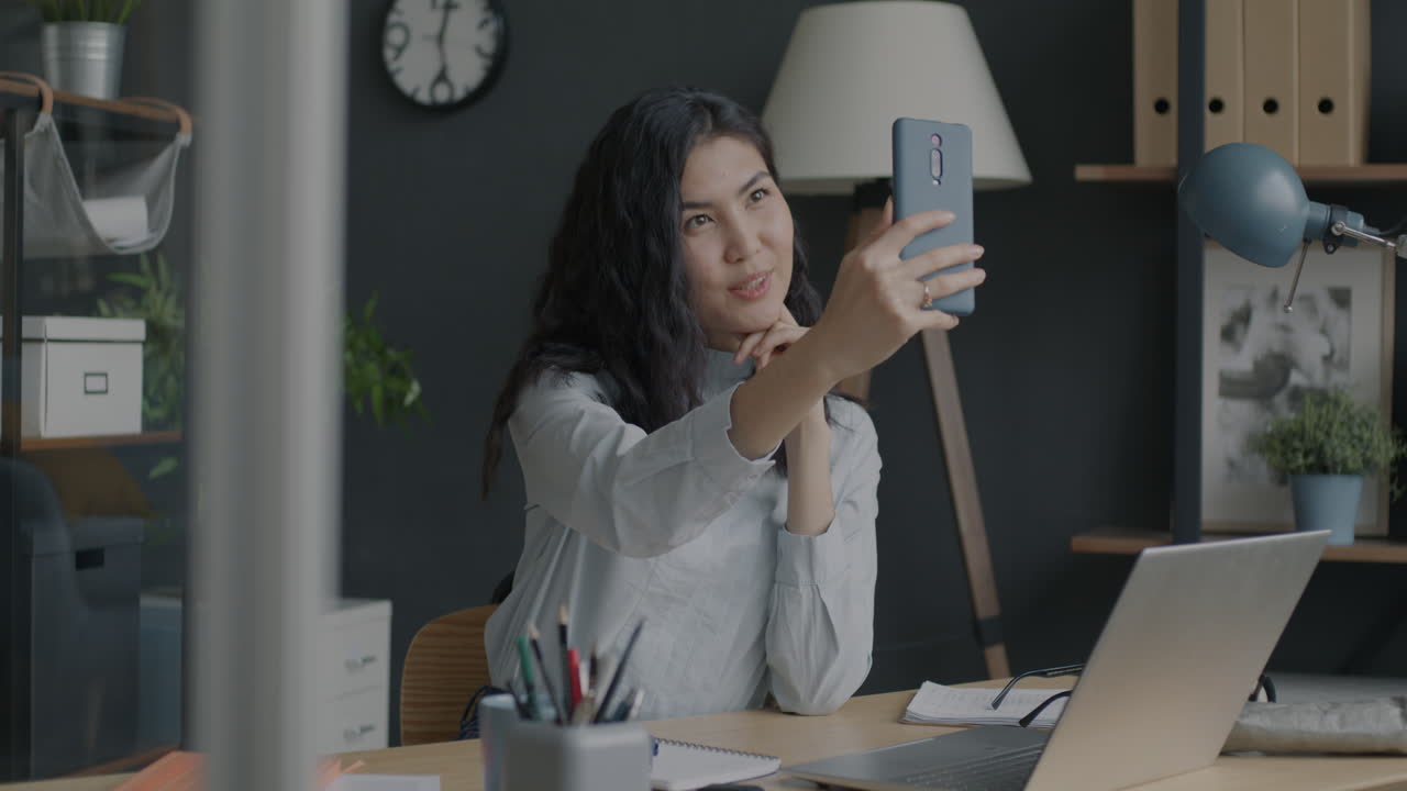 Woman taking a selfie in a modern office
