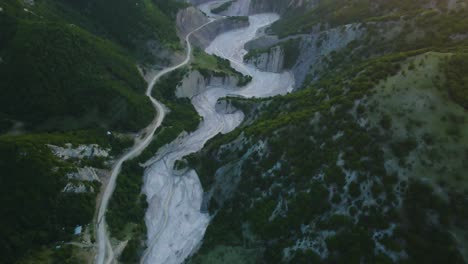 Drone-shot-flying-over-the-Girdimanchay-river-near-the-town-of-Lahic,-Azerbaijan-during-sunset