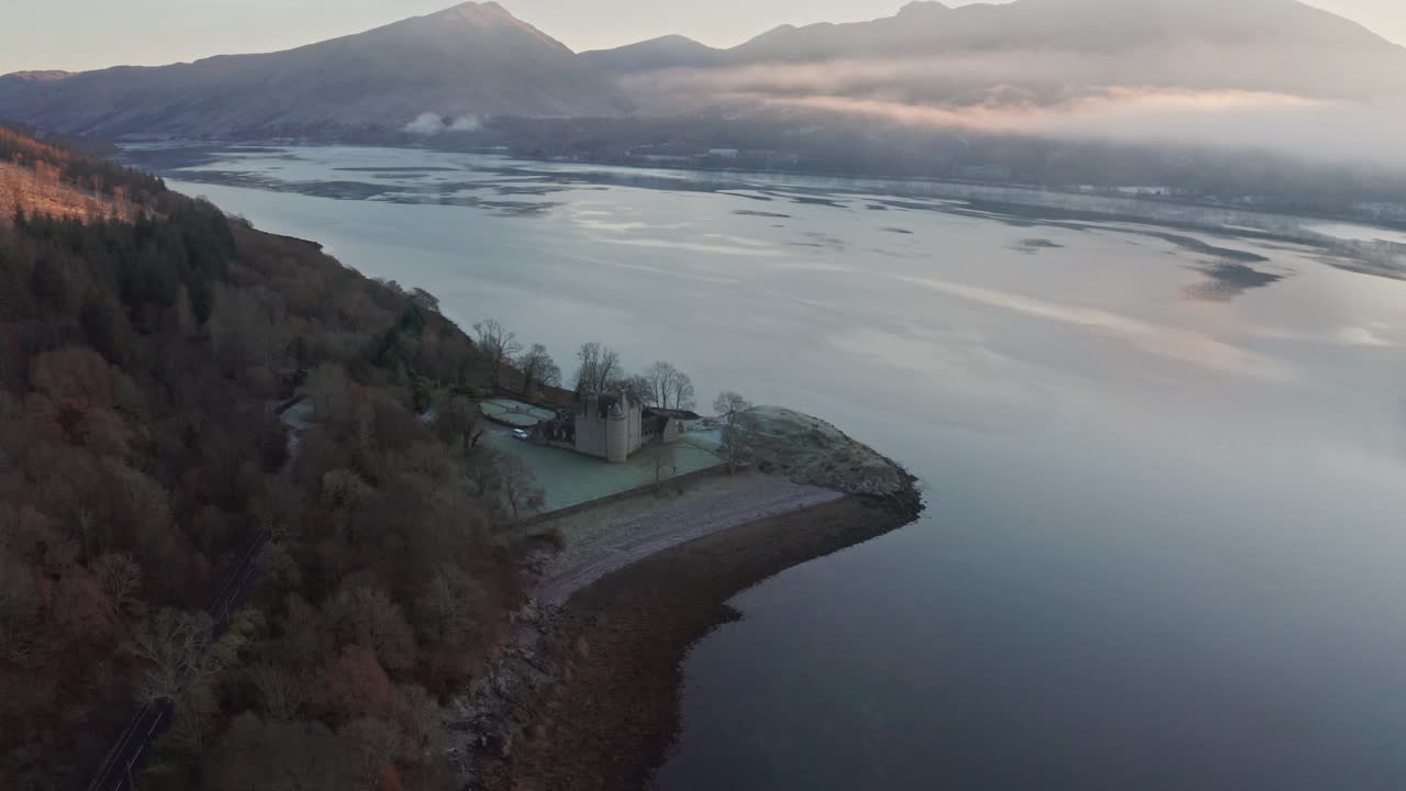 Flying over the beautiful Dunderave Castle in the Trossachs National Park in Scotland - aerial