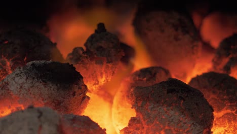 close up of red hot glowing coals on fire