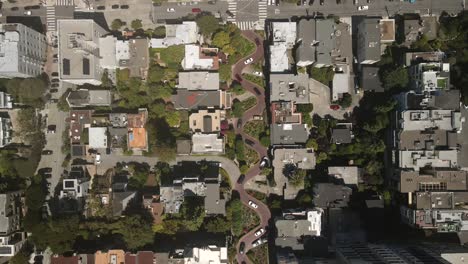 capture of the san francisco residences using a drone, featuring aerial and cinematic shots that highlight a winding road through the middle, with vehicles in motion