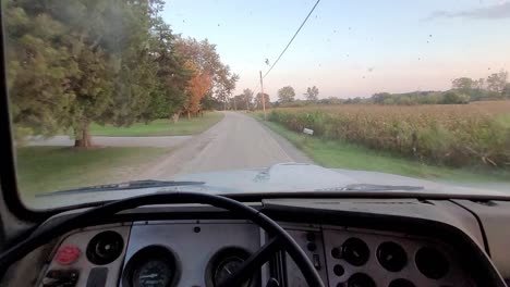 driving old truck on gravel road of rural america, pov view