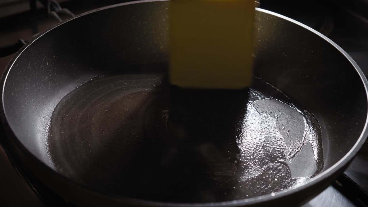 Chef Greasing Hot Frying Pan With Butter