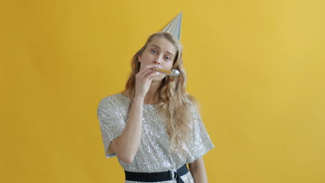 woman celebrating with party hat and party horn