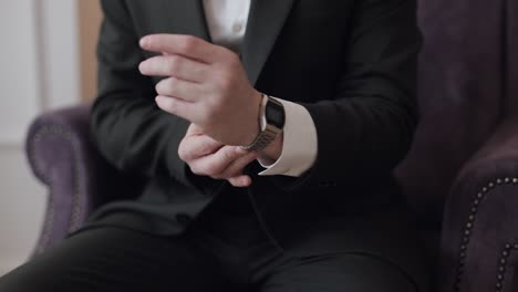 man put on wrist watch, groom dresses, male businessman waiting for meeting, hand with clock