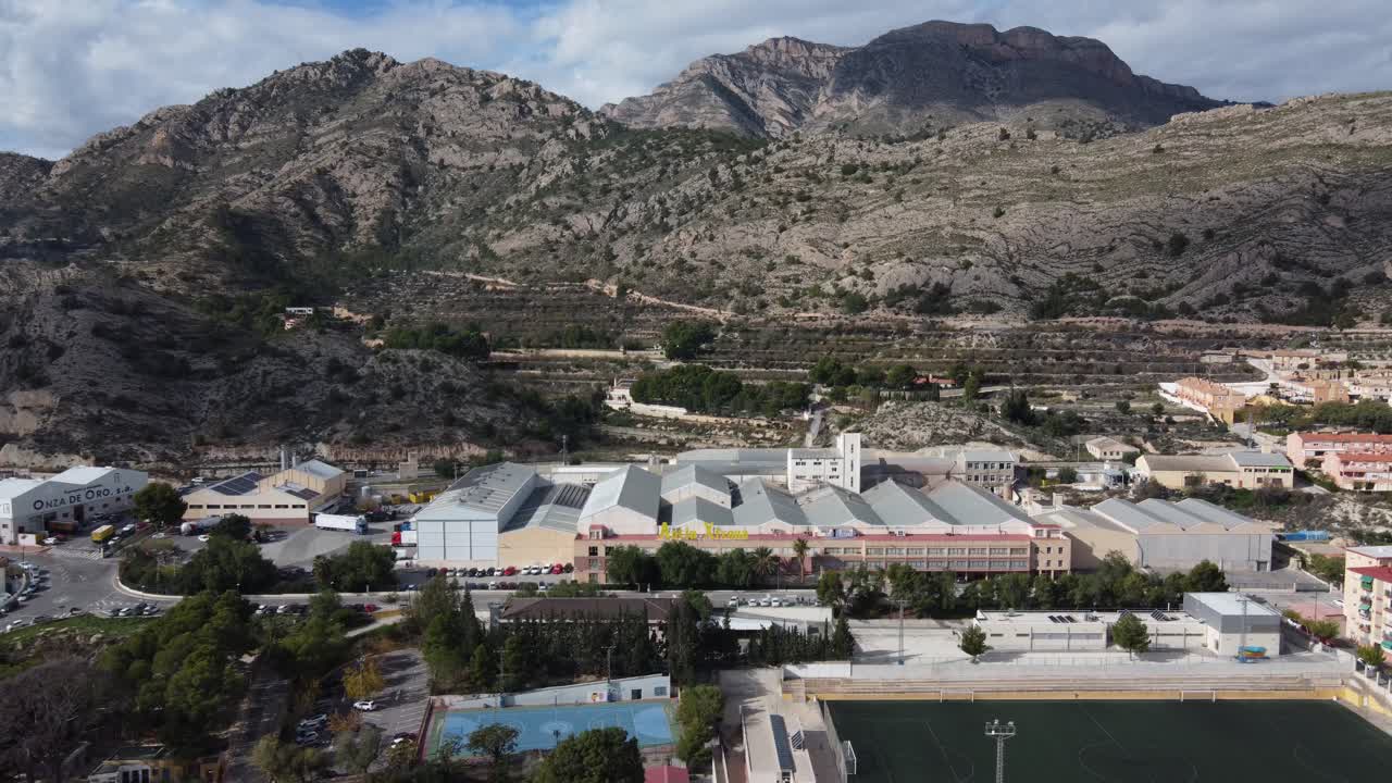 Aerial View of a Factory and Town Nestled in Spanish Mountains