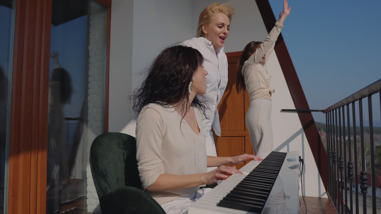 Friends Dancing and Playing Piano on a Balcony