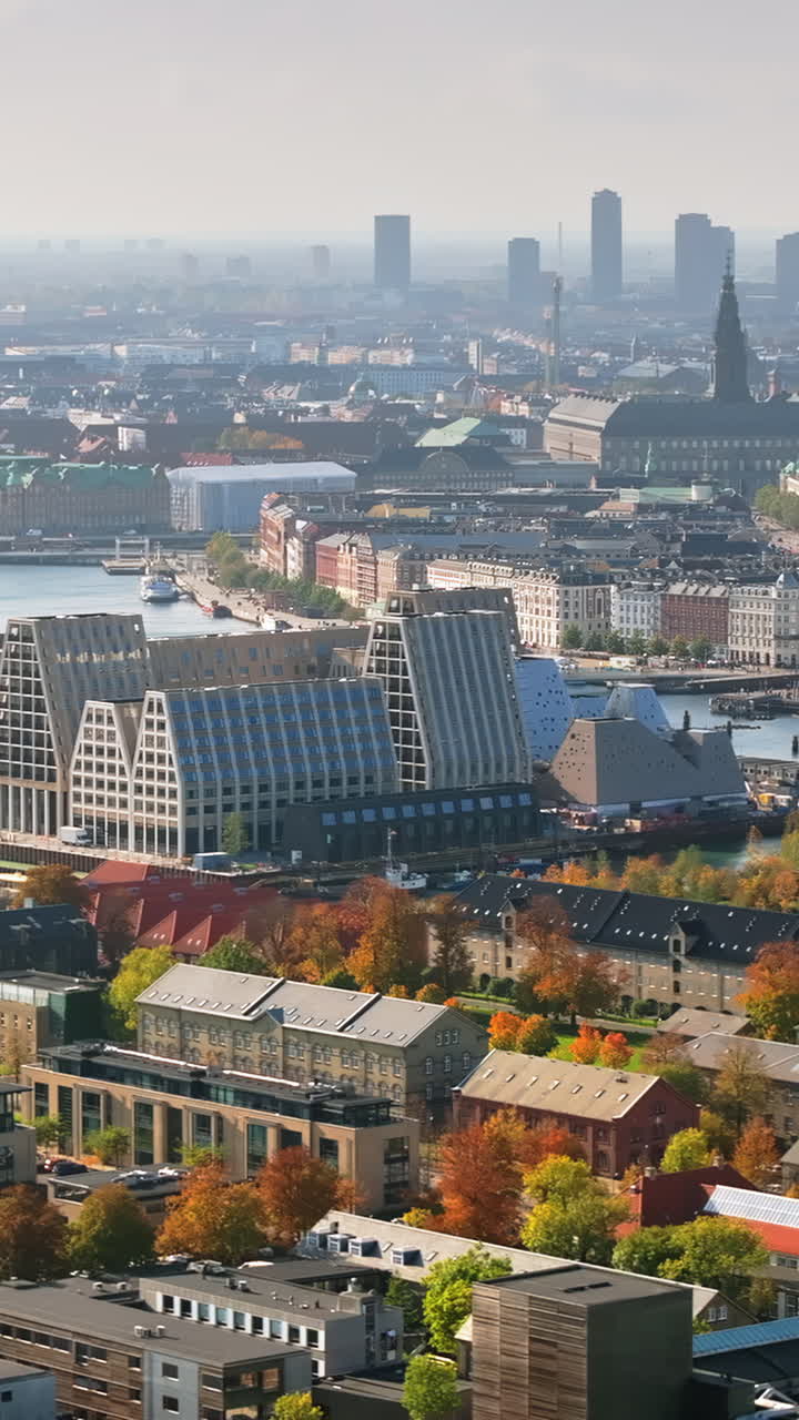 Aerial drone view of the Paper Island urban oasis surrounded by water in Copenhagen, Denmark in daylight. Vertical