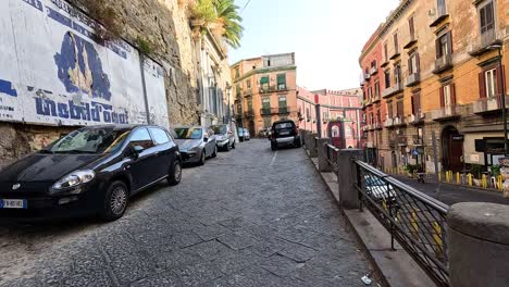 cars parked along a narrow cobblestone street