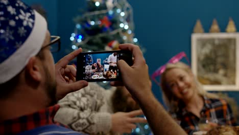 laughing friends having roasted turkey at christmas dinner