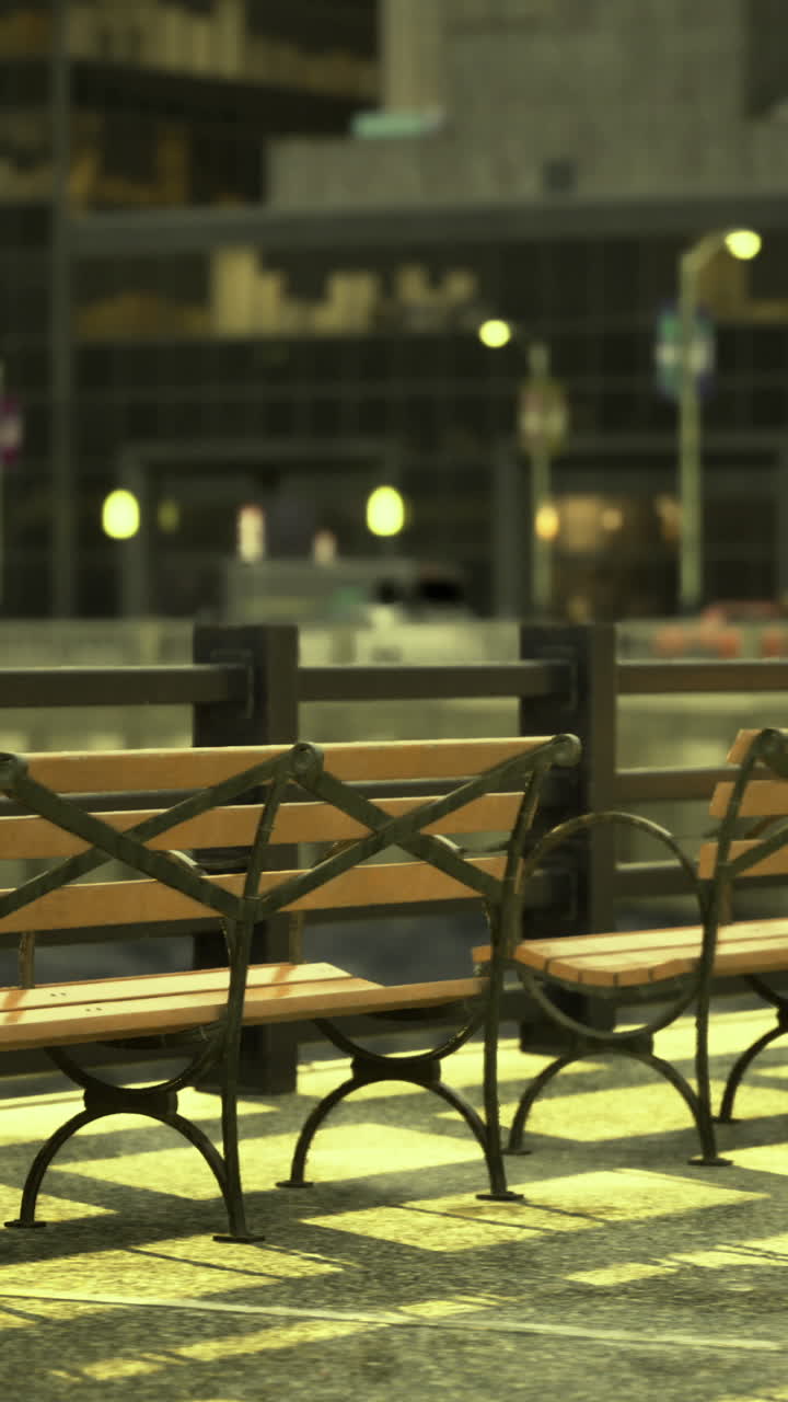 Benches along the riverside walkway illuminated by city lights at night