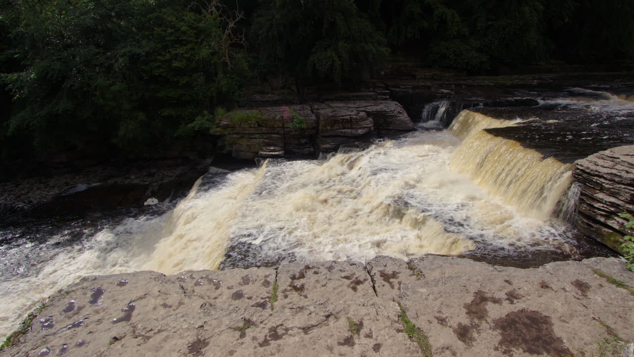 side on shot of the lower falls at Aysgarth falls on the river ure, Yorkshire dales