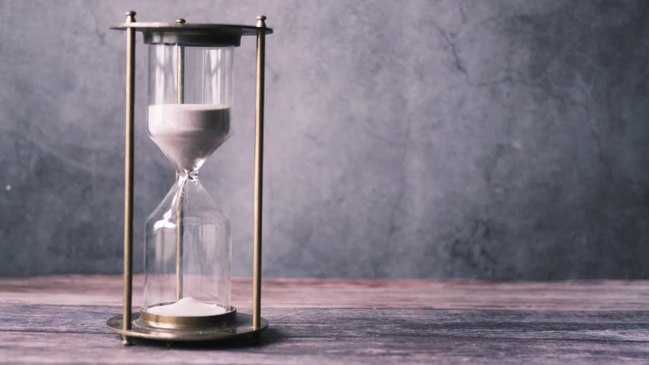 Vintage Hourglass on Wooden Table