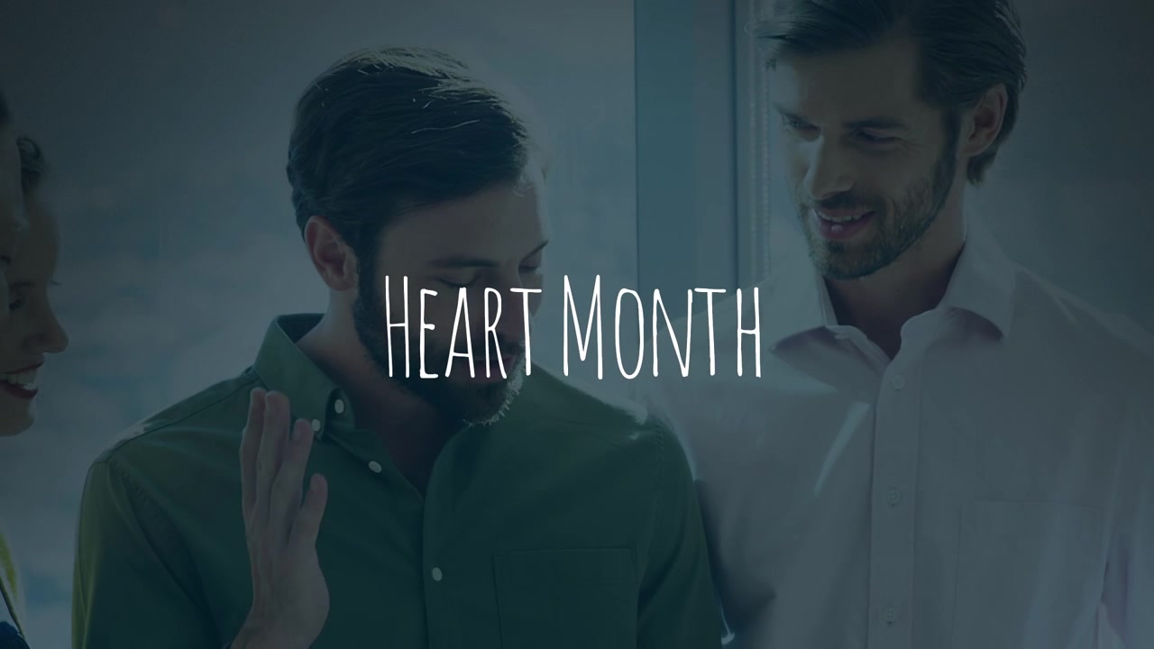 Animation of heart month over happy caucasian coworkers in office