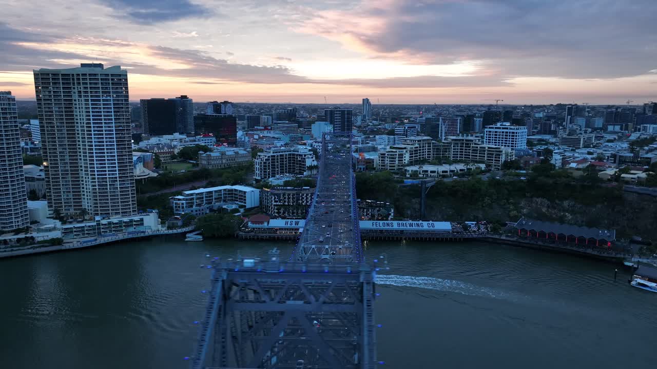 Drone shot of Story Bridge, camera orbiting Howard Smith Wharves with Story bridge in foreground