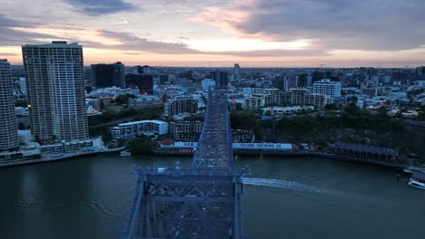 Drone-shot-of-Story-Bridge,-camera-orbiting-Howard-Smith-Wharves-with-Story-bridge-in-foreground