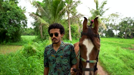 Young-handsome-man-with-brown-horse