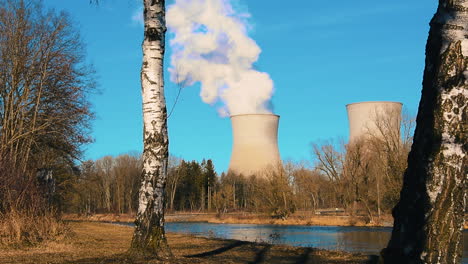 cooling tower of nuclear power plant in the landscape with small river