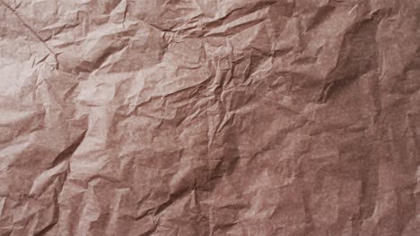 Video-of-close-up-of-crumpled-brown-paper-texture-background