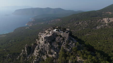 aerial view orbiting the castle of monolithos, sunny summer day in rodos, greece