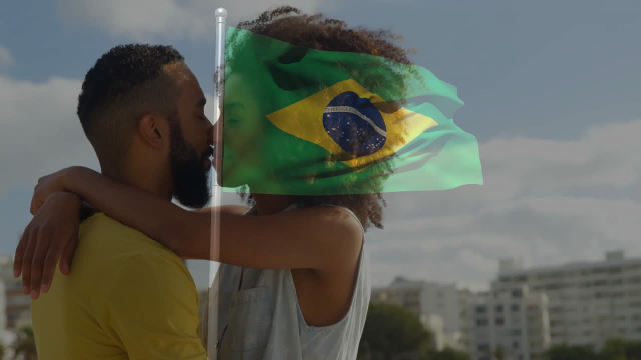 Embracing with Brazilian flag overlay, couple standing against cityscape background