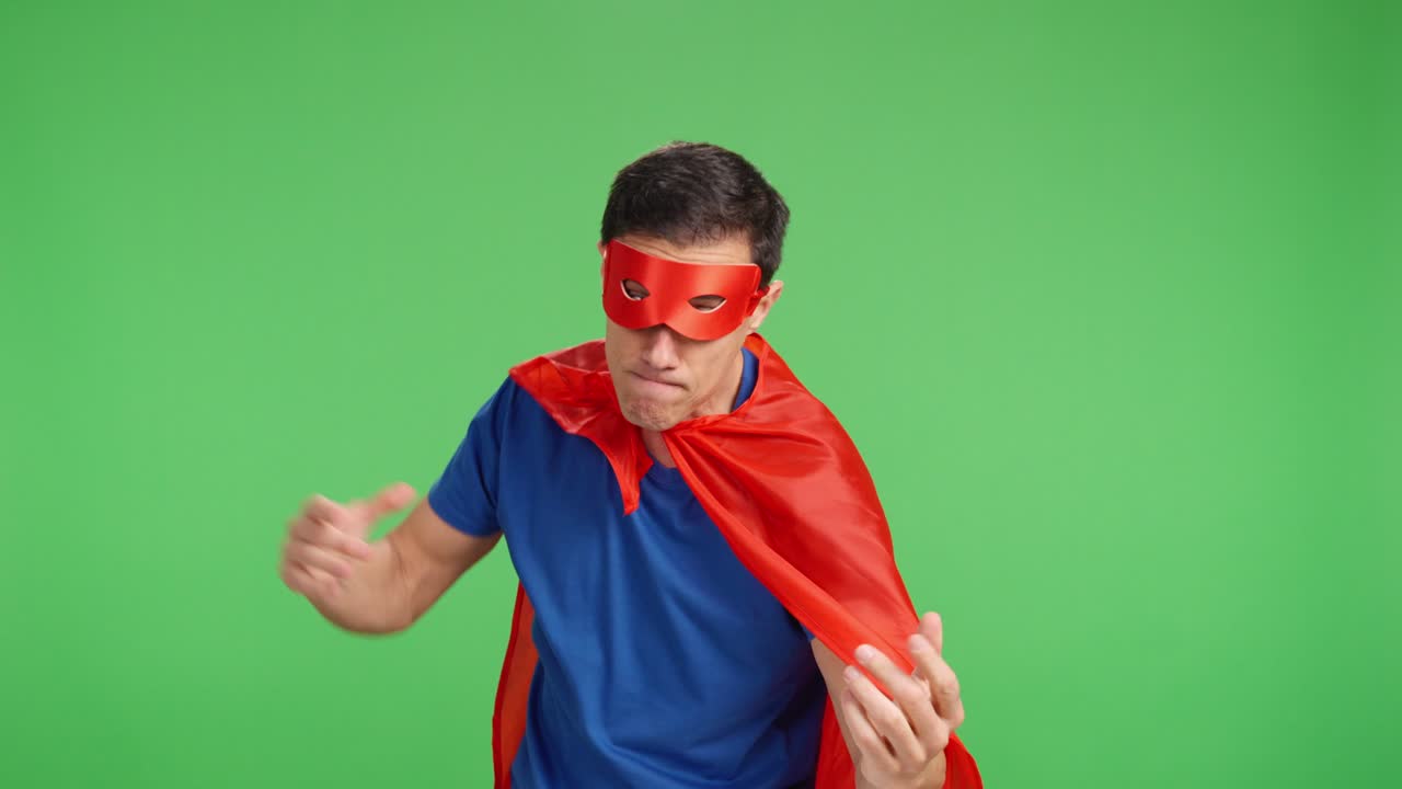 Confident hero striking poses against vibrant green studio backdrop