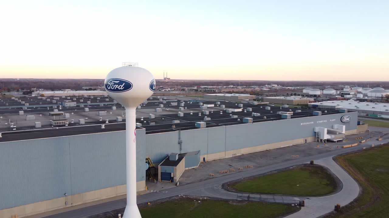 Water Tower In Front Of Ford Woodhaven Stamping Plant In Wyandotte, Michigan - aerial drone (orbiting)
