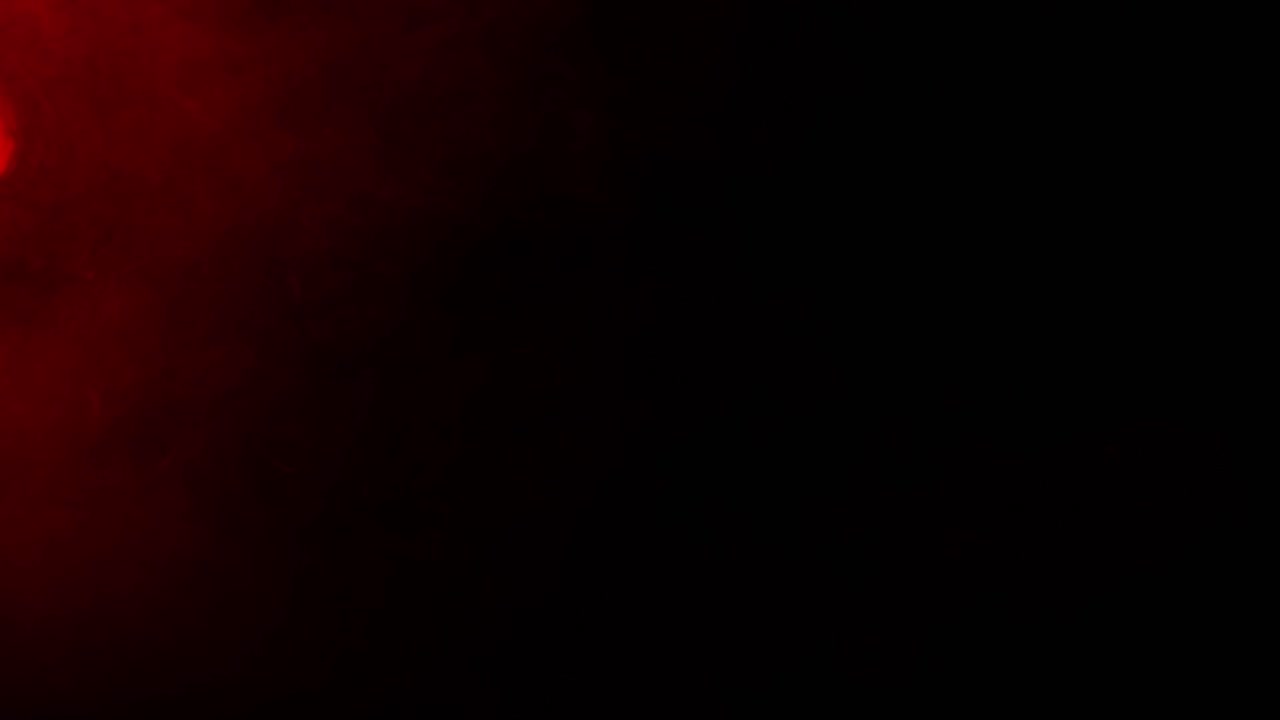 Subtle red fog or mist drifts slowly from corner of black screen, eerie and mysterious background element for horror or suspenseful scenes