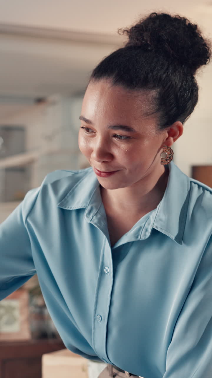 Young Woman Smiling and Looking Down in an Office Setting