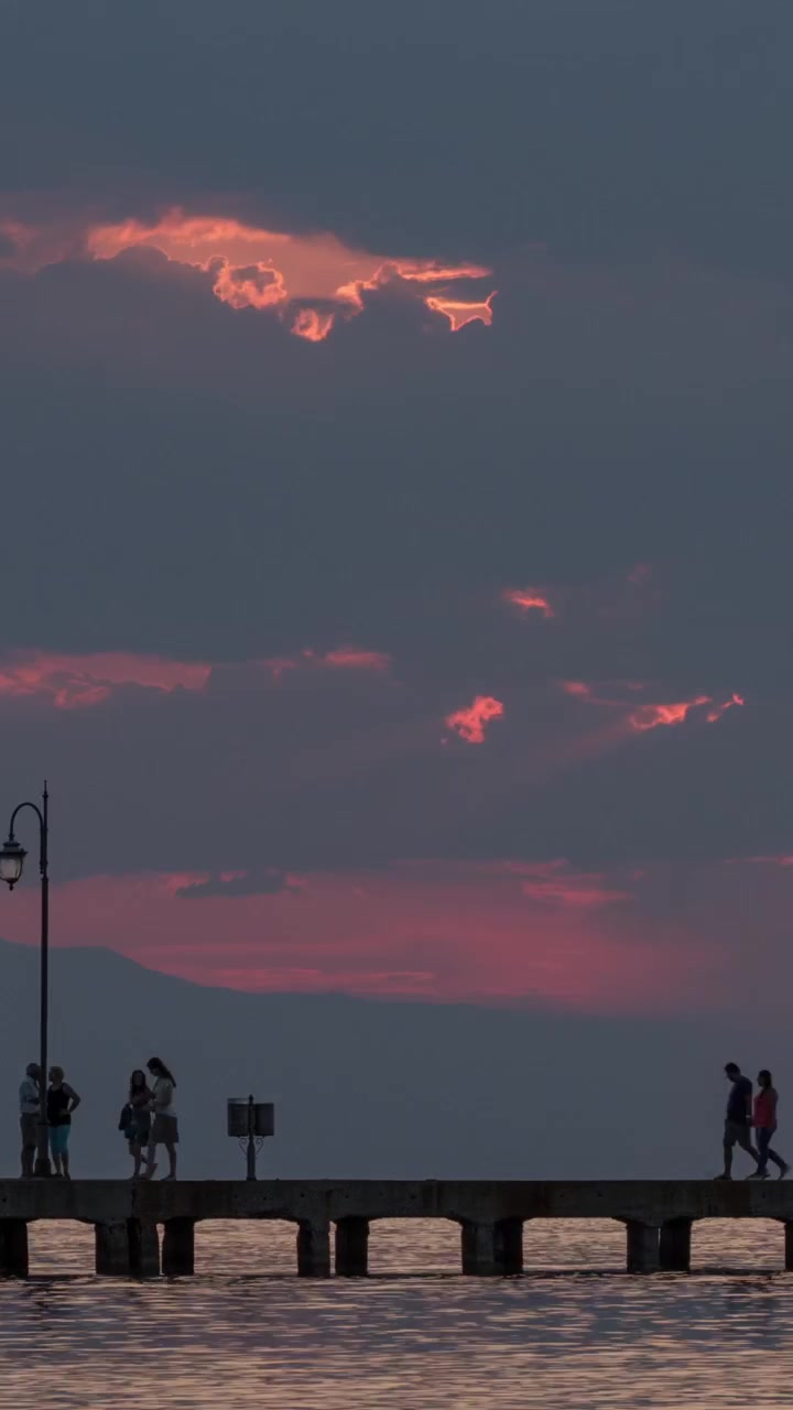 Timelapse of people on pier in the evening