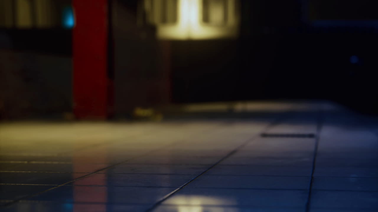 Mysterious empty corridor with dim lighting and reflections on tiles