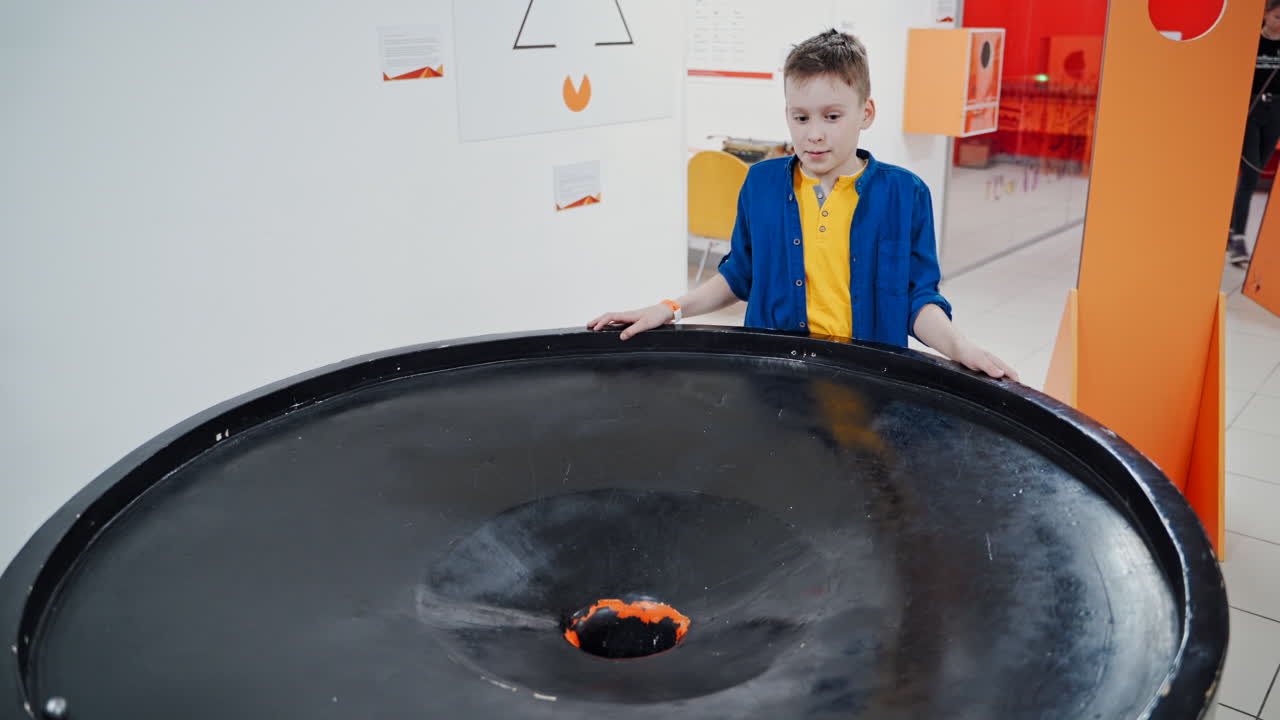 Boy in the museum science. Gravitational field model of black hole