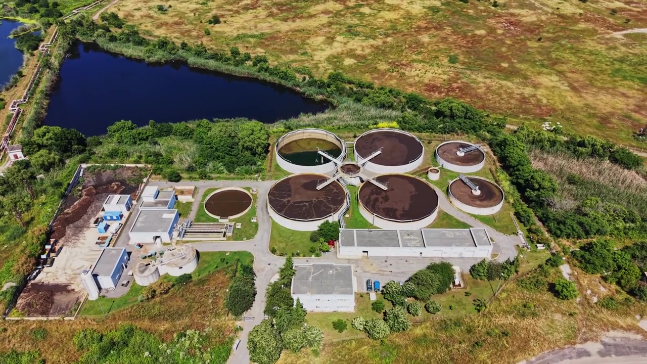 Water treatment facility located near a river surrounded by green land