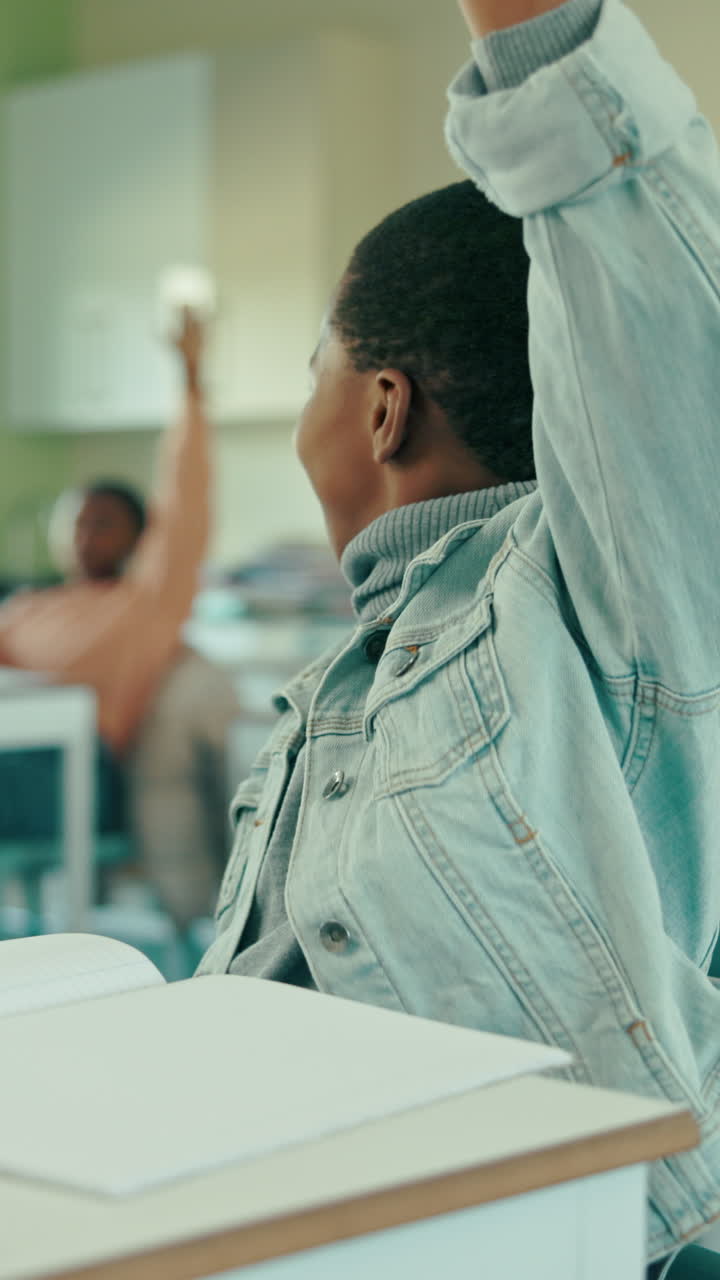 Happy Young Boy Raises Hand to Answer Question in Classroom