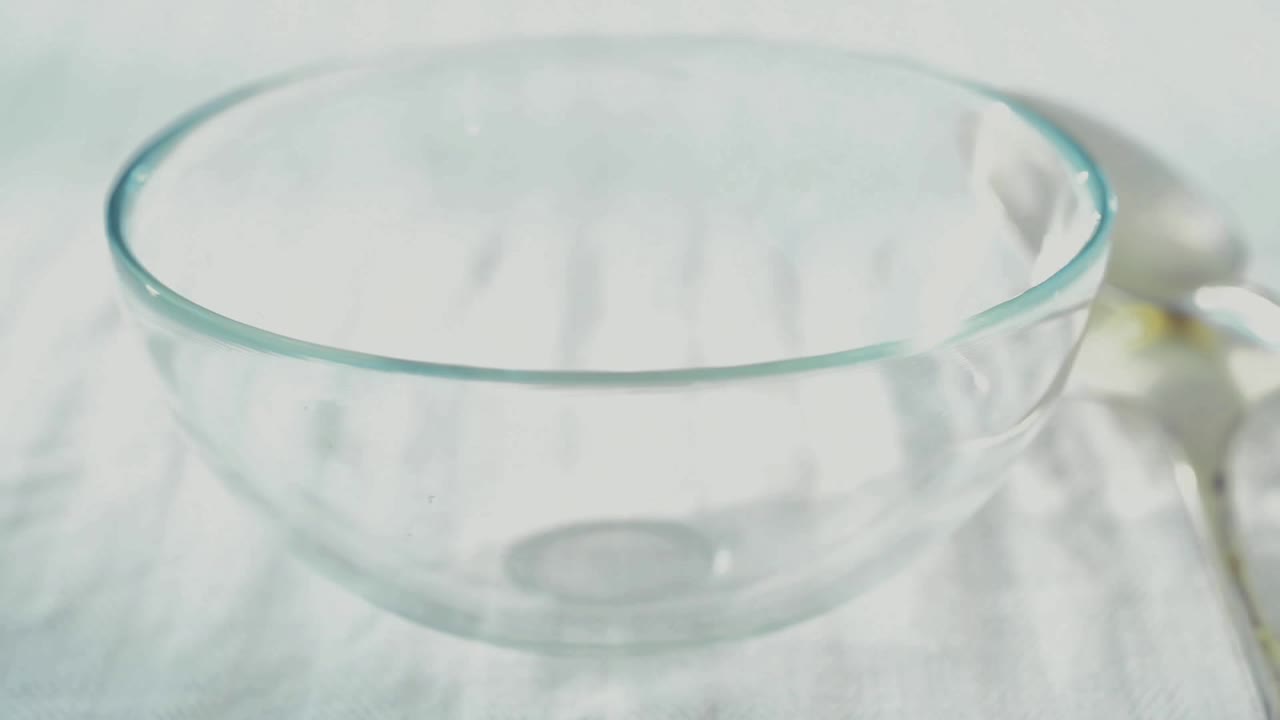 Cereal falls into a bowl