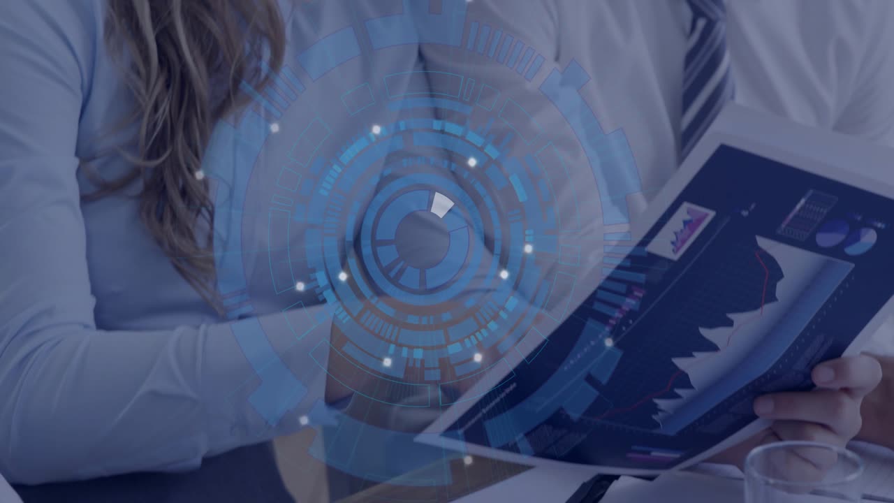 Two coworkers writing reports at table, HUD appearing and aligning with rising chart for business