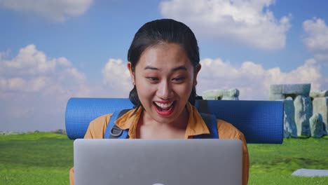 Excited Woman on Video Call at Stonehenge