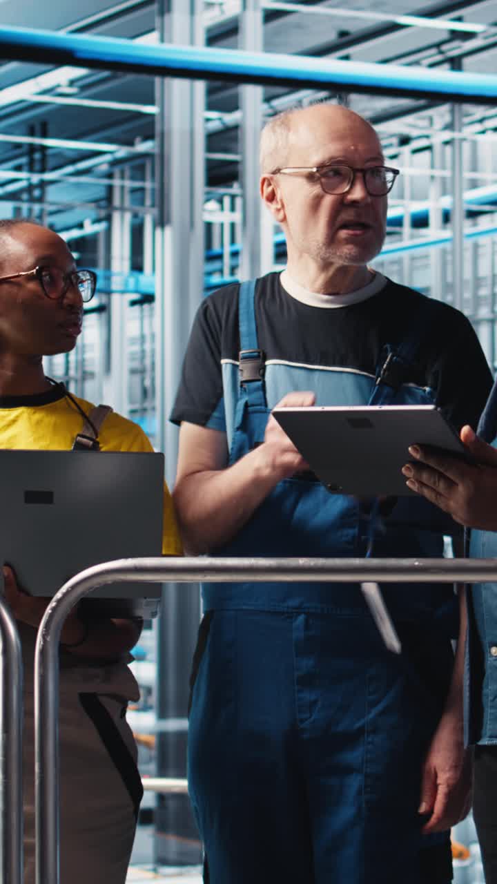 Vertical video Smart factory engineering team colleagues implement automated workflows