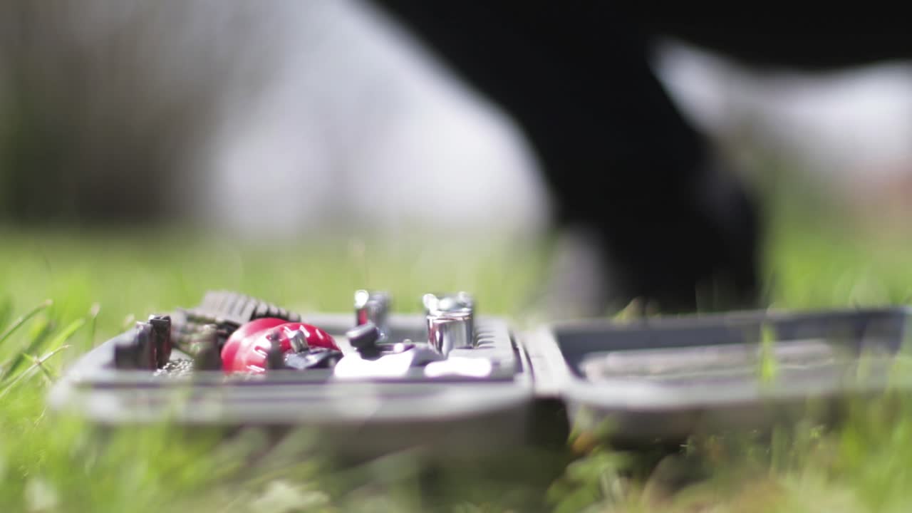 Person preparing tools from a tool kit. Screws and screwdrivers. Mechanic. Outdoors workshop.